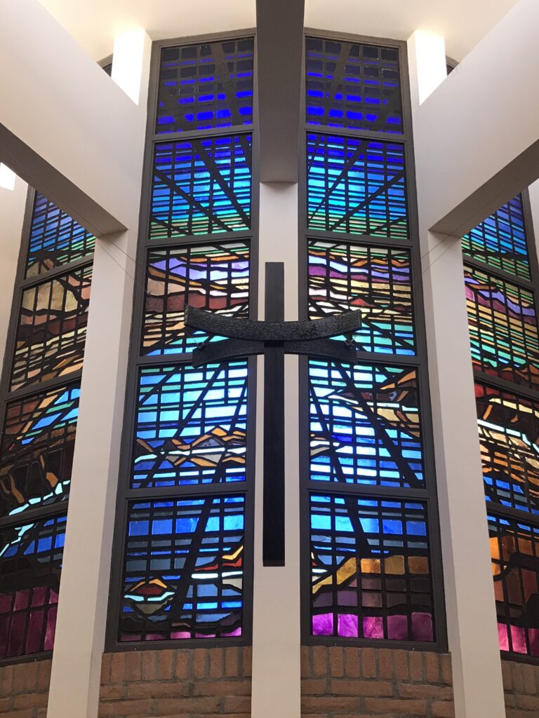 Picture of stained glass window with a cross